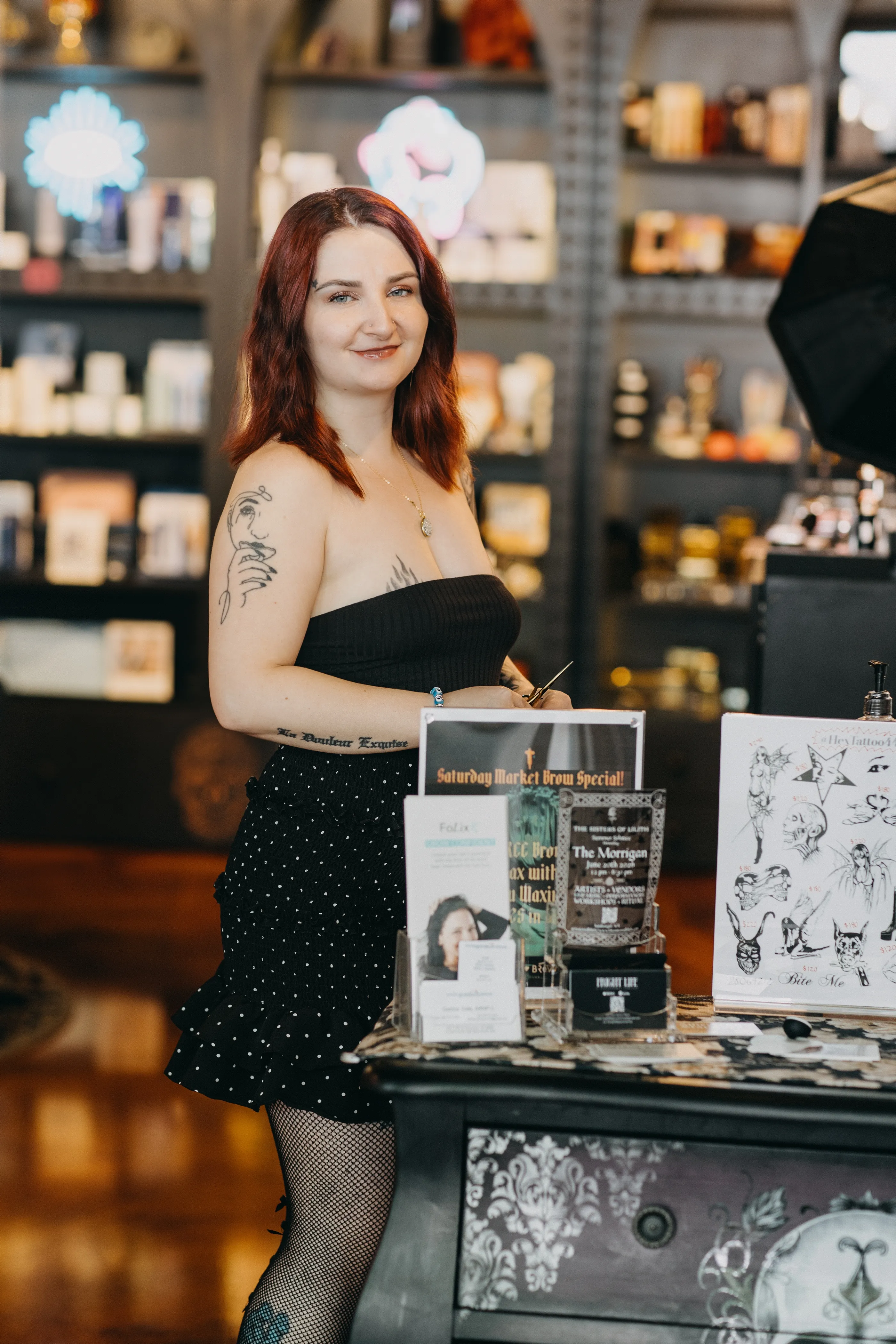 Lilliana Grace greeting customers entering the Speakeasy Market at the High Brow Social Club front counter.