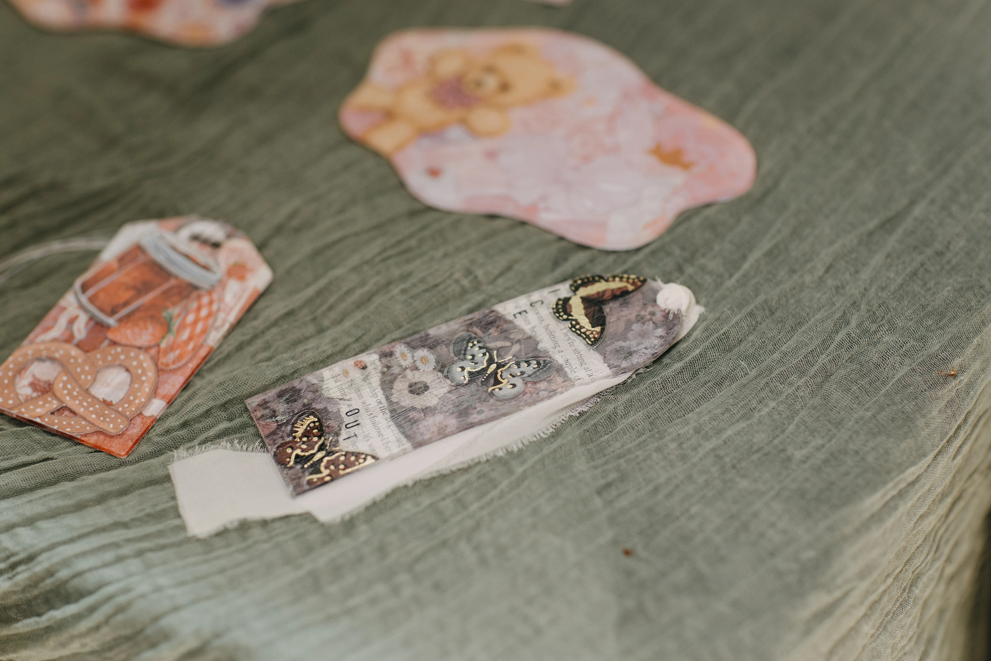 A bookmark that looks like butterflies that have been dried and pressed between vintage book pages.
