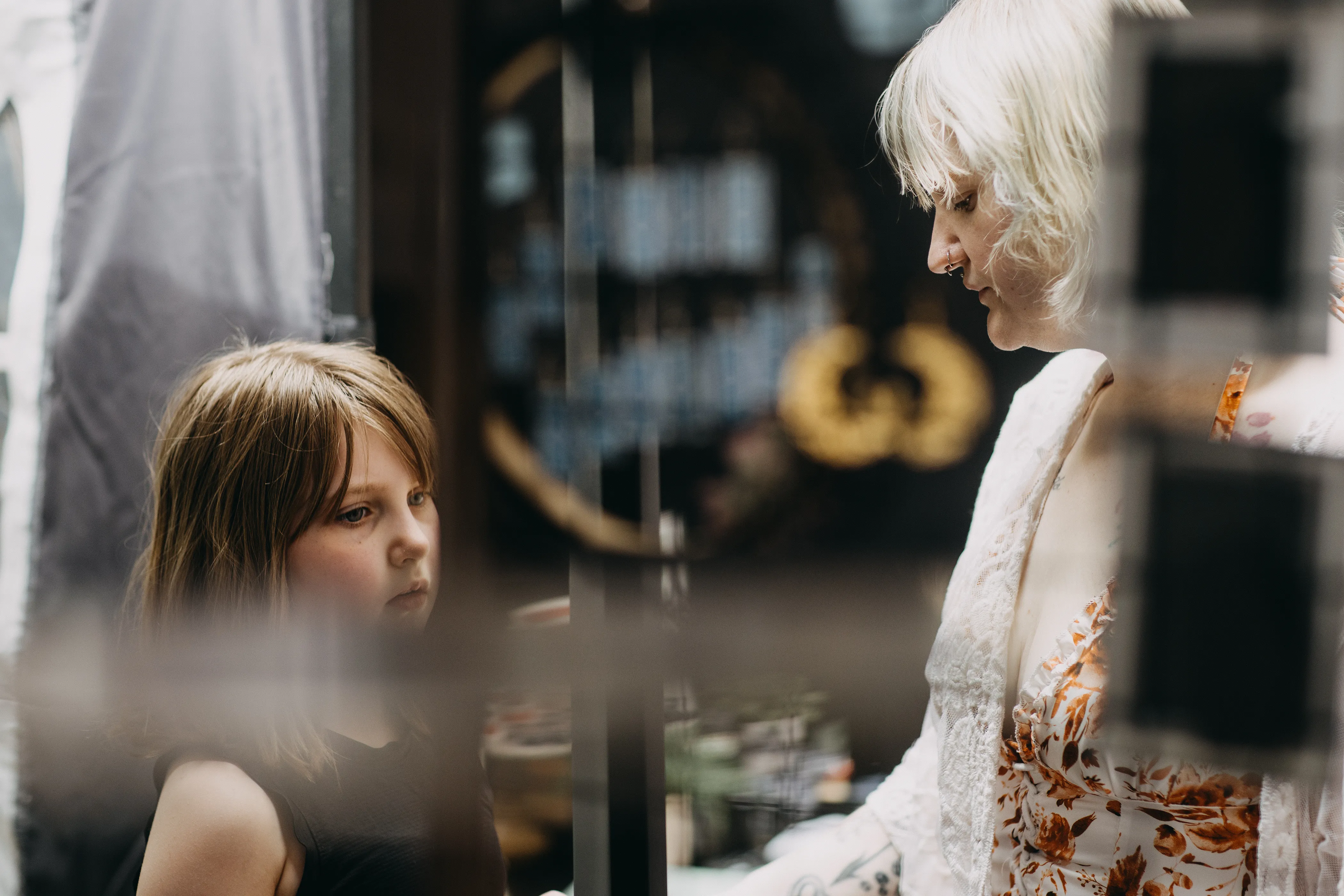 A child looking intently at some displays of oddities.