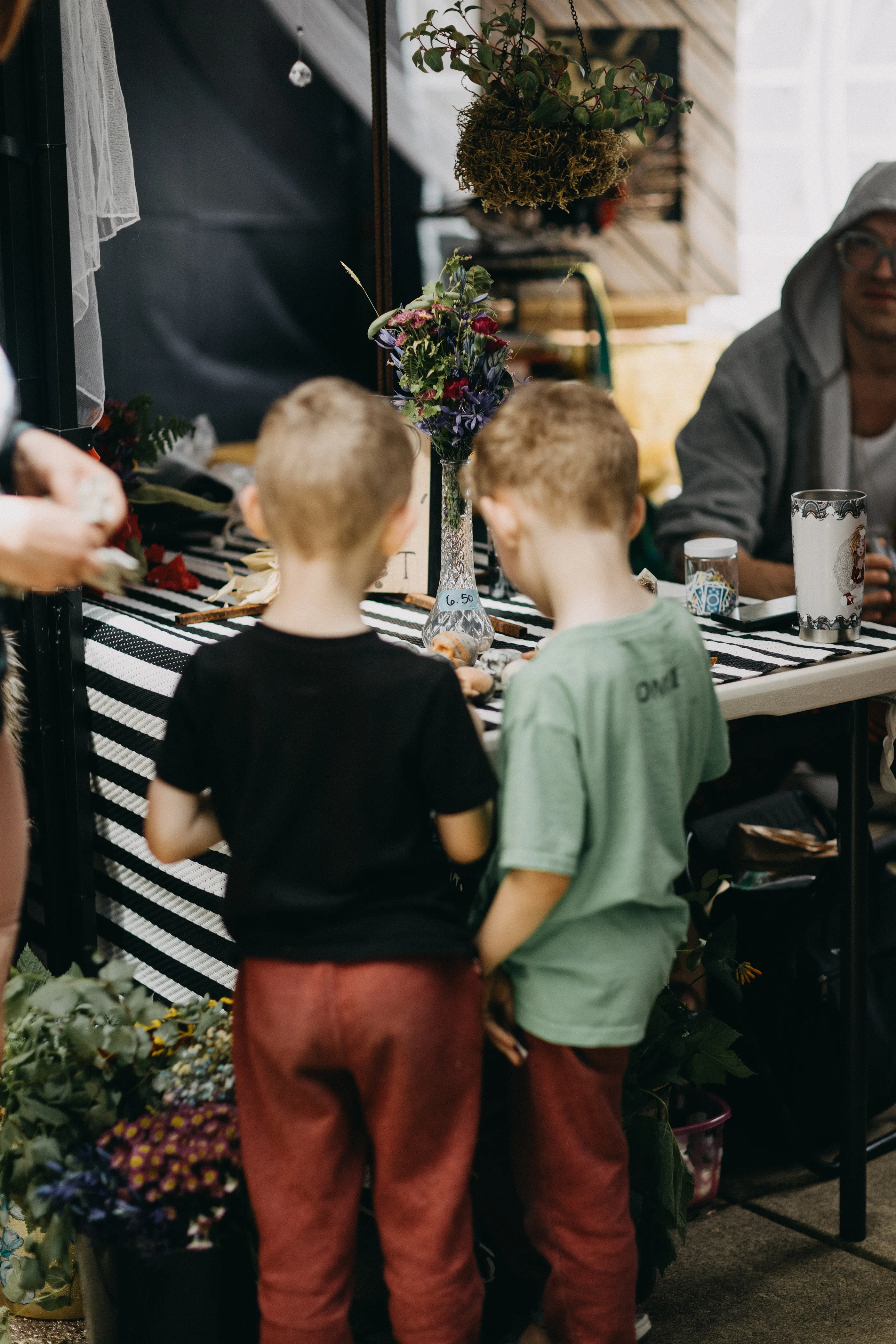 Children fascinated by a tabletop display of oddities.